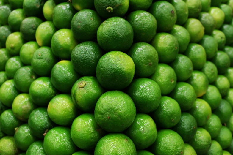 some green limes sitting next to each other