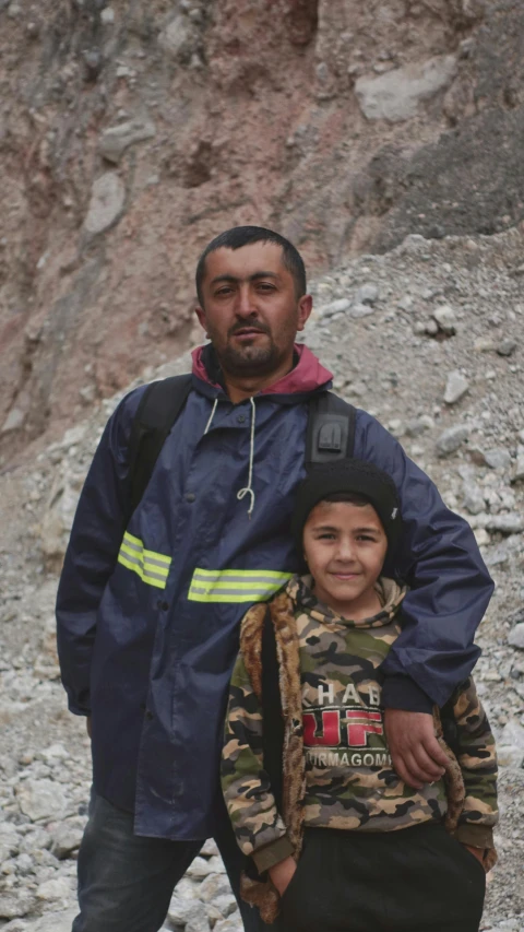 a man and his son hiking down a mountain trail