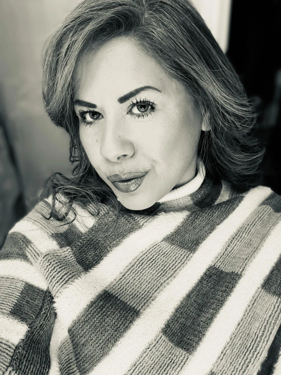 a woman in a striped sweater with her tongue out