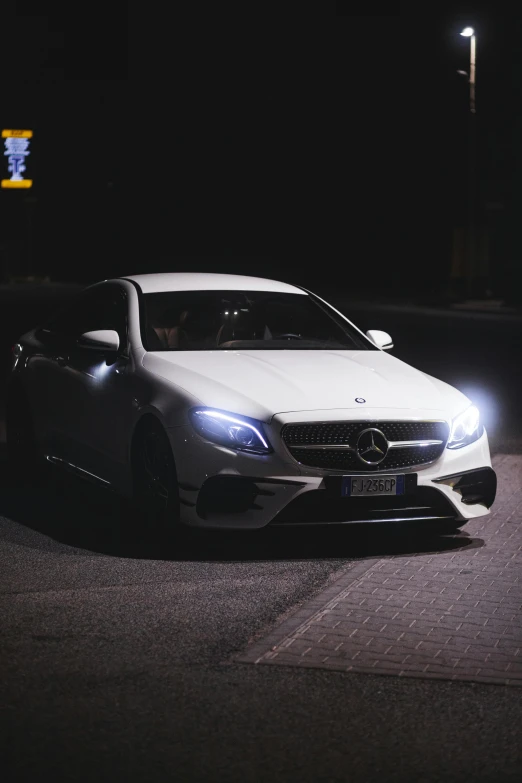 a mercedes benz amg on an empty street at night