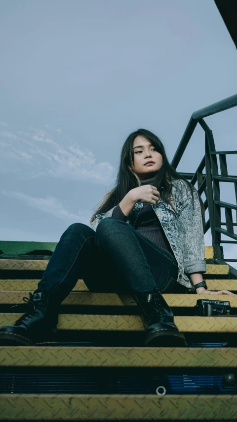 the woman is posing on a stair case