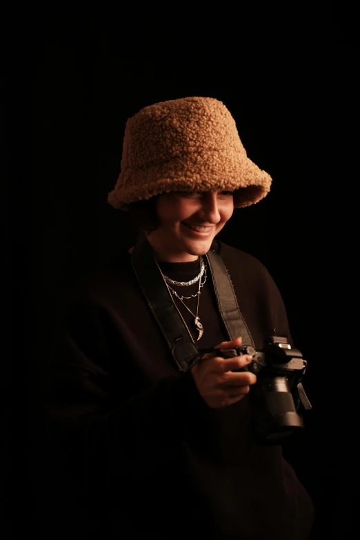 a person is holding a camera in a dark room