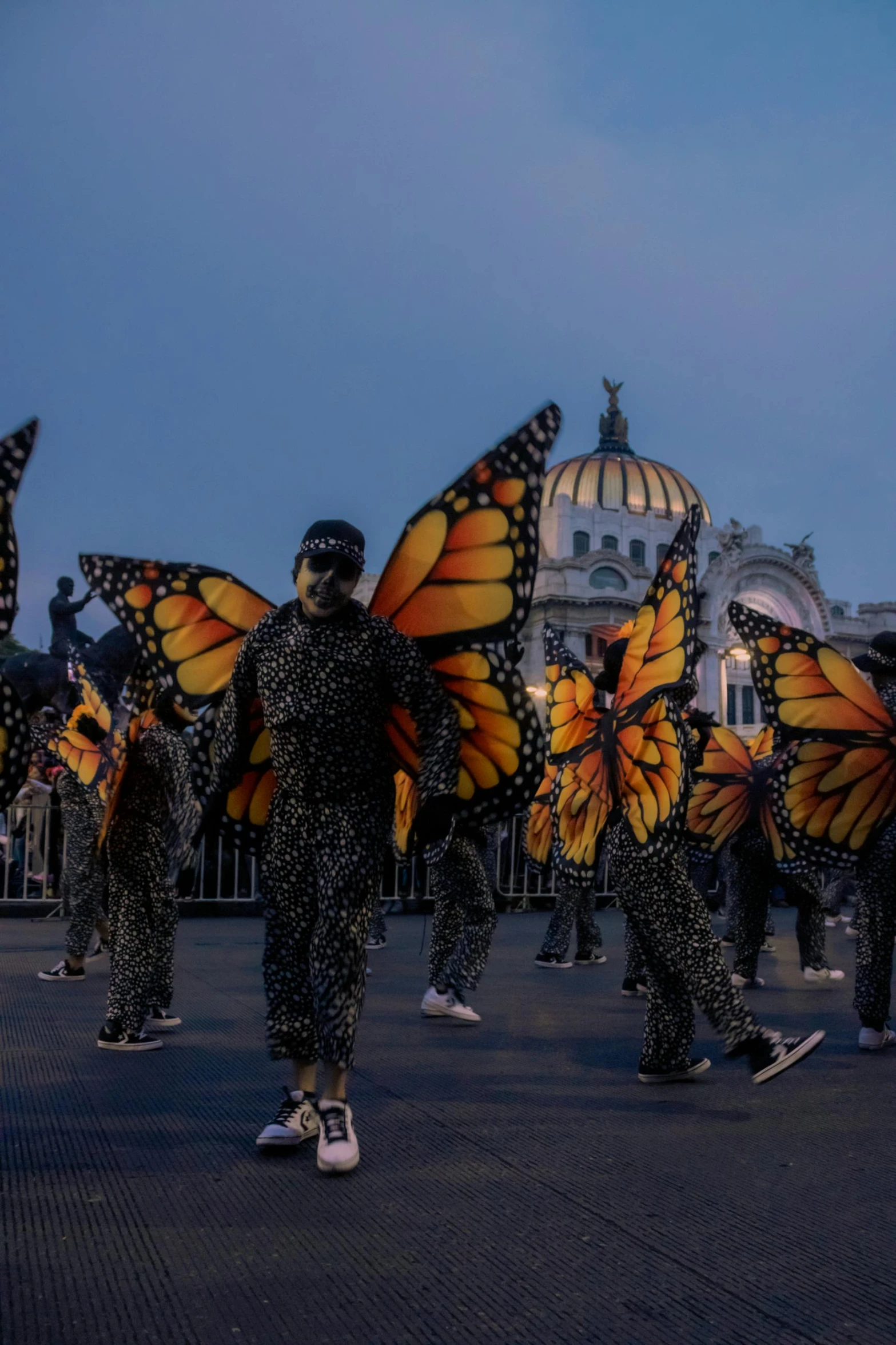 several people in fancy attire wearing erflies