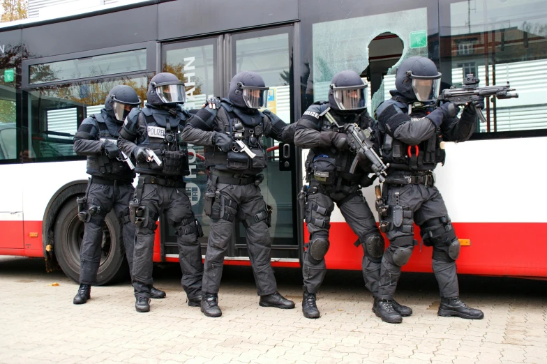 a group of swat personnel are getting into a bus