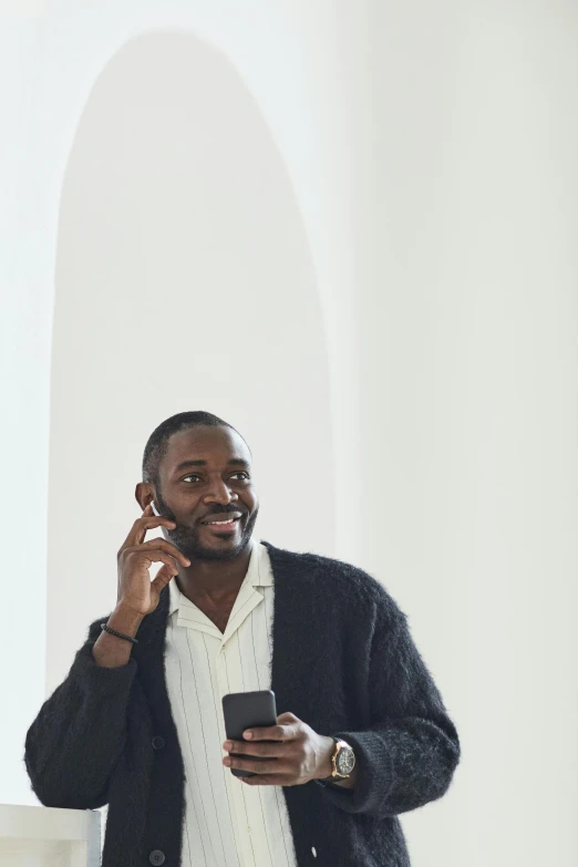 a man stands and talks on his cell phone