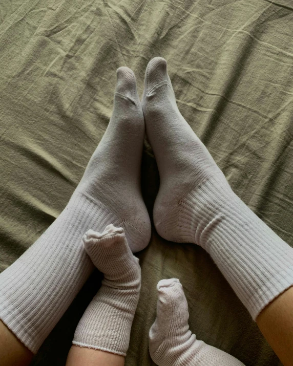 a pair of feet wearing grey sock socks