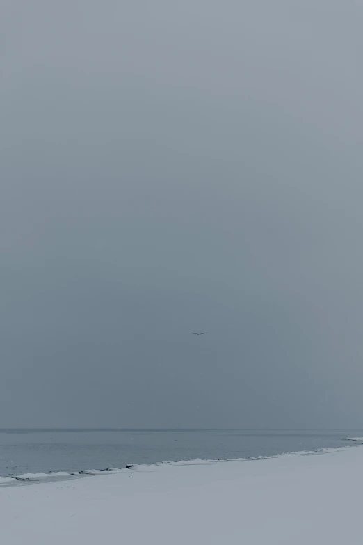 a beach that has a boat floating in the ocean