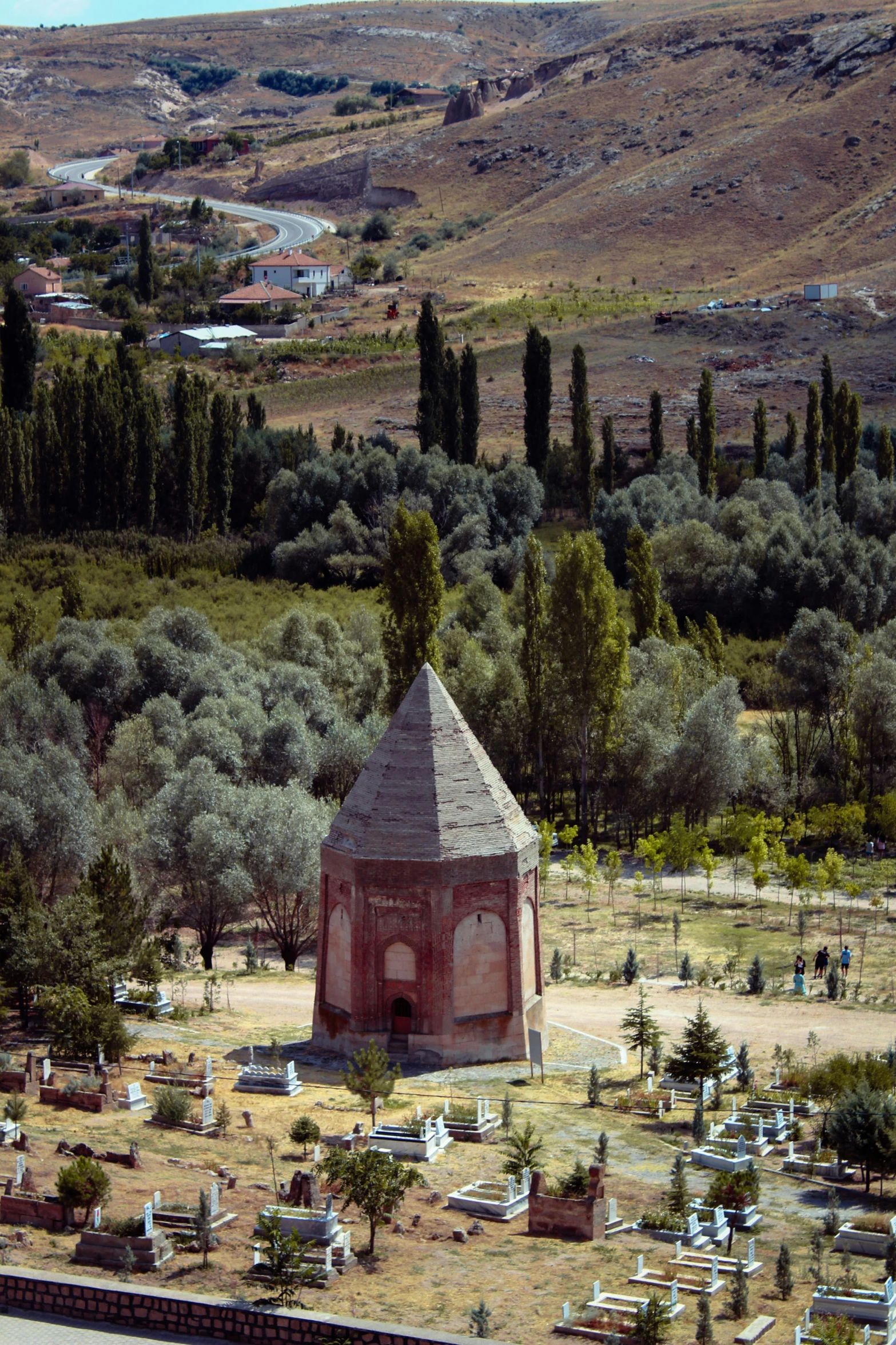 a large cemetery with an outhouse in the middle