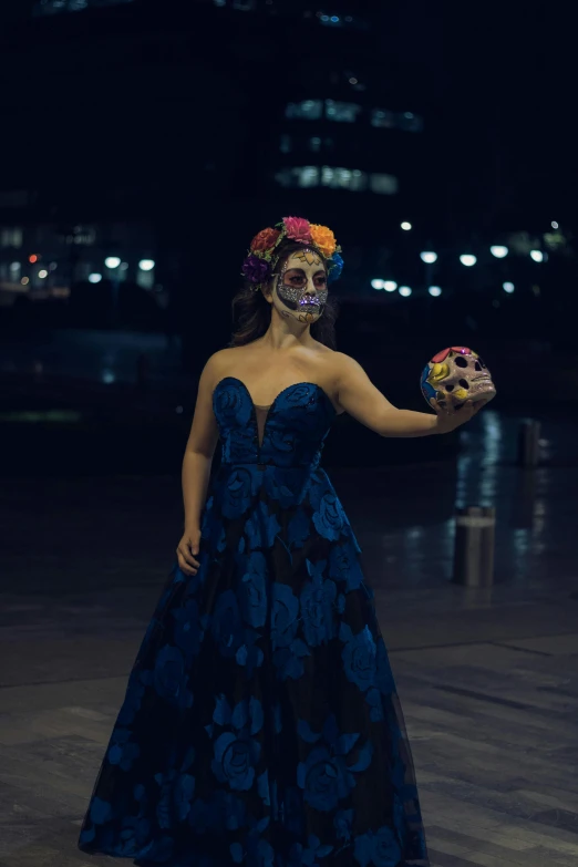 a woman holding a doughnut in her right hand