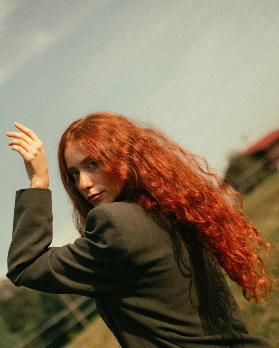 a red - haired woman is tossing a frisbee