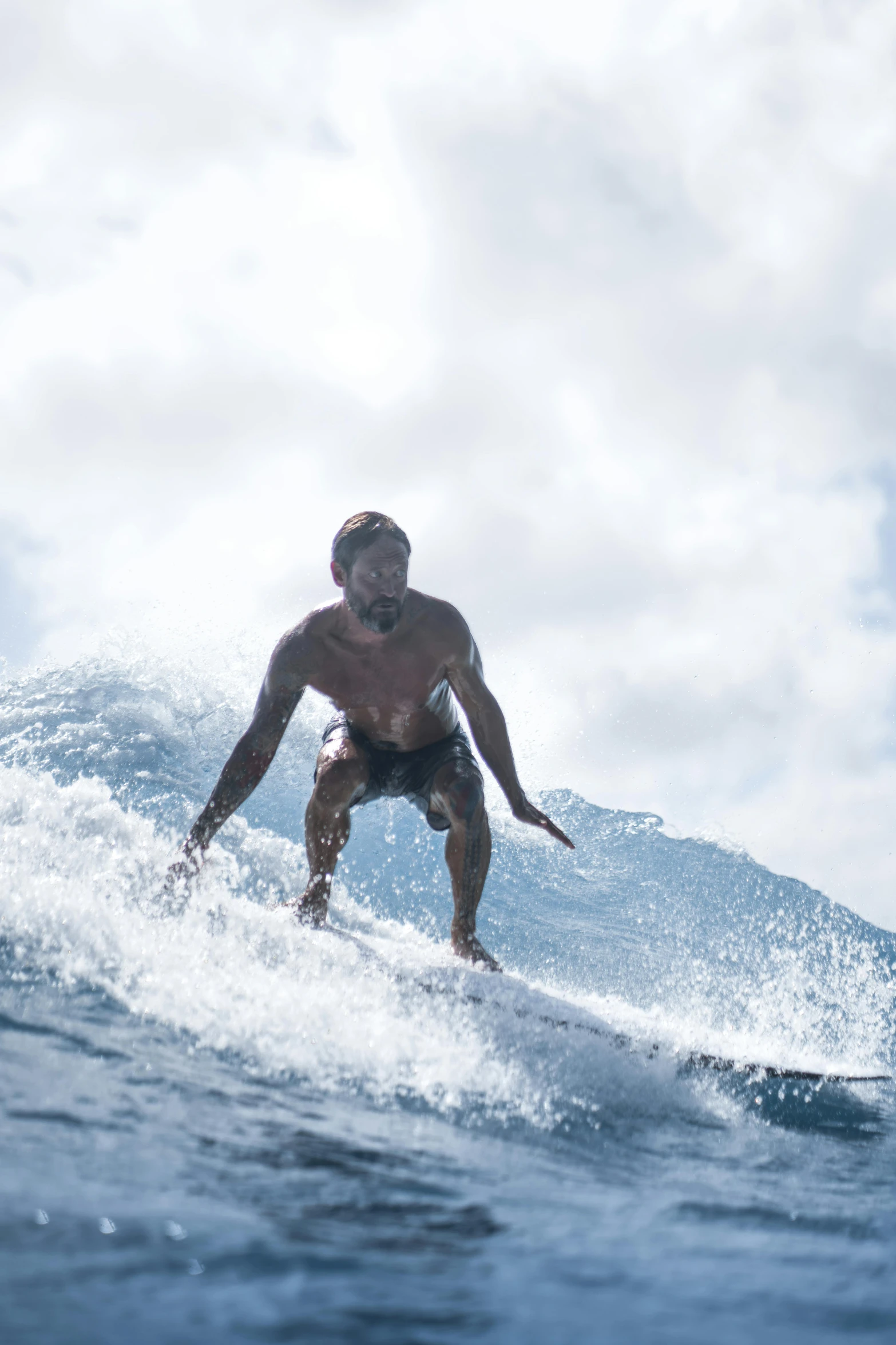 a young man surfing a small wave with a sky background