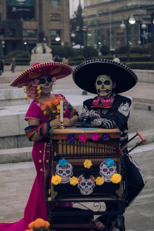 a couple dressed in sombreros and mask on