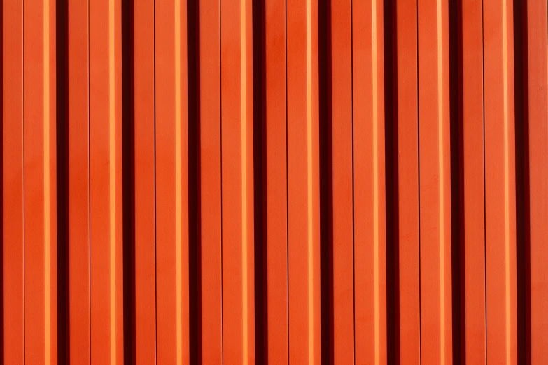 the top of an orange wall, with vertical bars