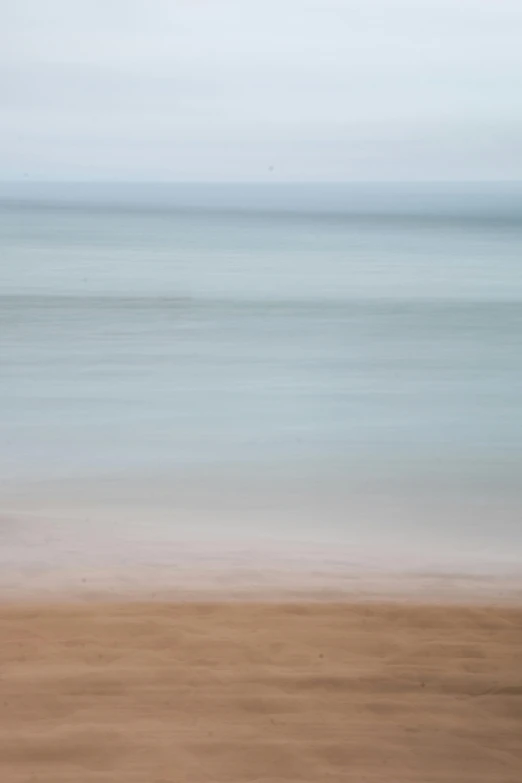 the back end of a brown surfboard on the beach