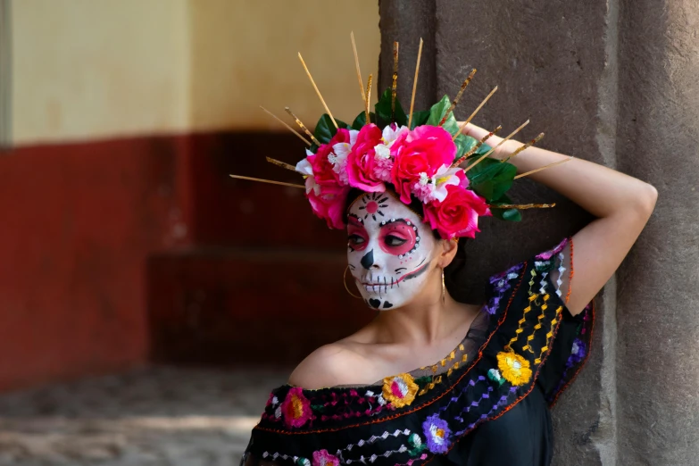 woman in day of the dead makeup with flower wreath