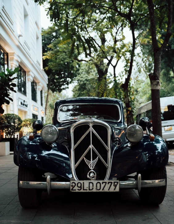 a very nice looking vintage car parked on a street