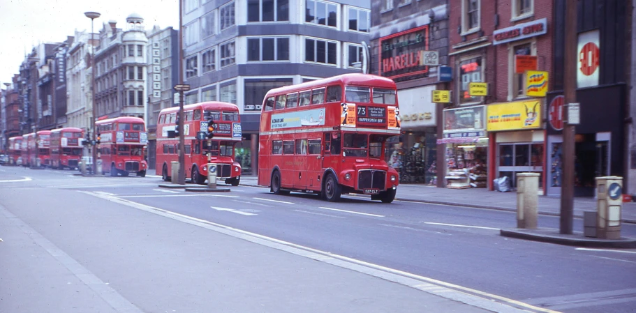 red double decker buses driving down a street