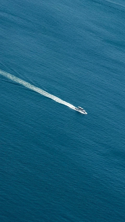 an aerial view of a boat in the ocean