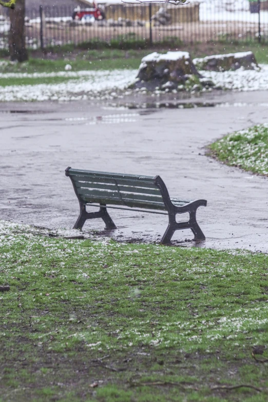 a bench sitting on the ground by some grass
