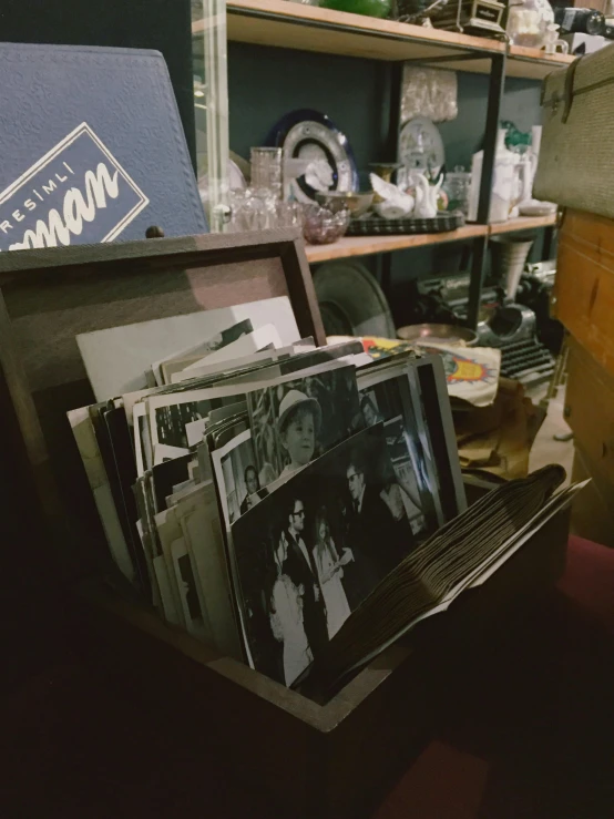an open case holds pos and magazines in a room filled with antiques