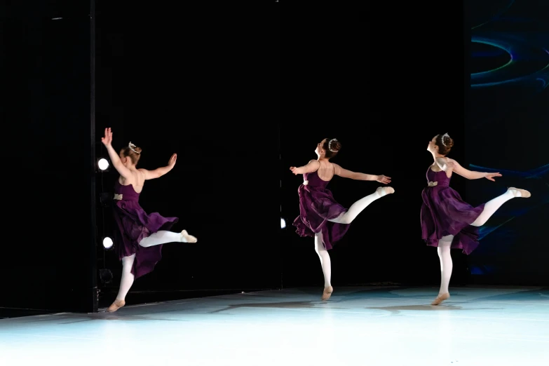 a number of dancers in motion while on stage