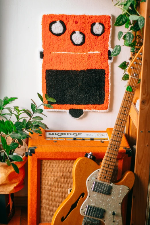 a picture of a guitar and a picture of a robot on a wall