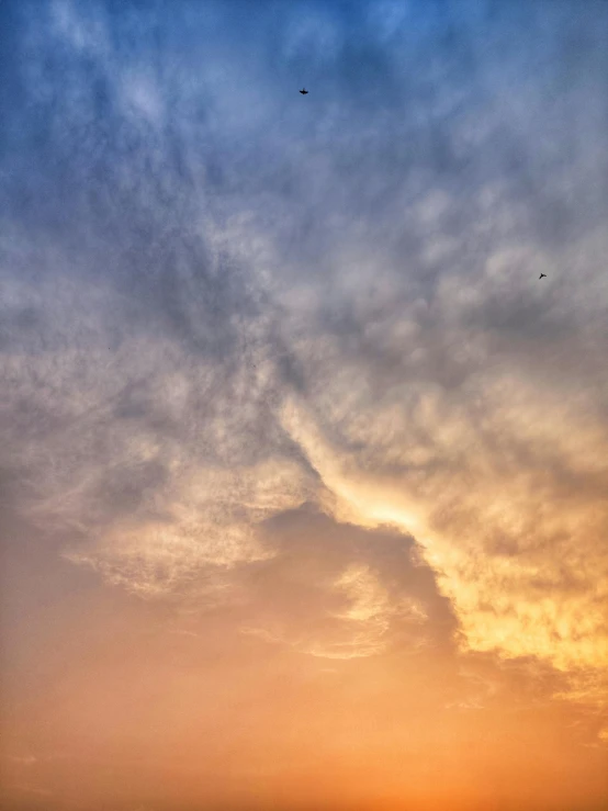 a plane is flying over the horizon during sunset