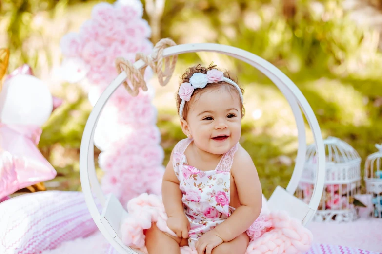 a baby sitting on the ground in a circular frame