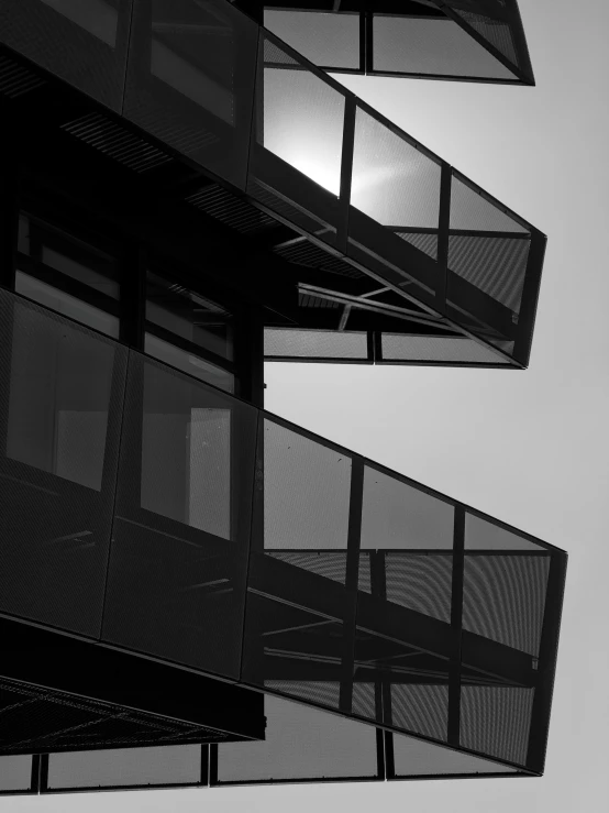 a pograph of several balconies outside on a sunny day