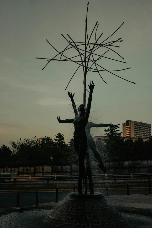 a statue is posed and holding two sticks