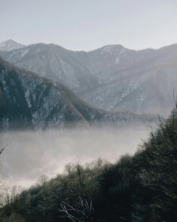 a view of mountains with fog in the valley below