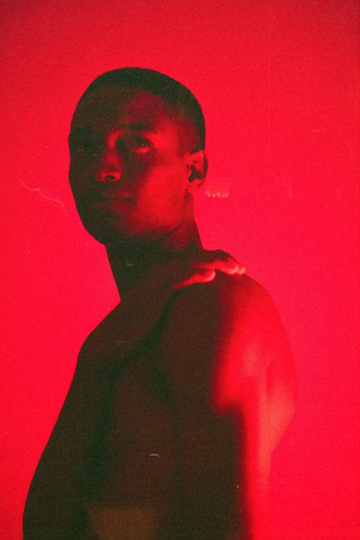 a woman in a red room in front of a light