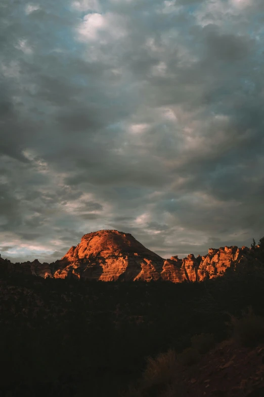 a mountain and some clouds in the sky