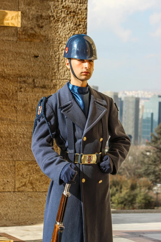 a man in blue uniform holding two guns