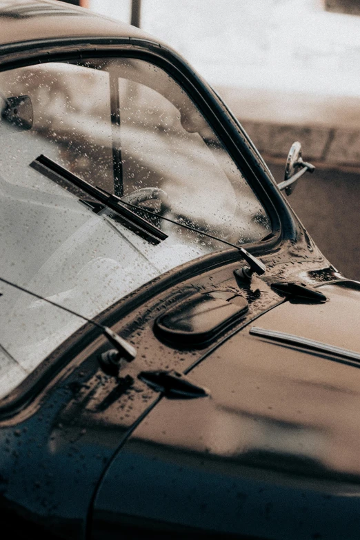 a close up view of the windshield of an old, rusty, black car