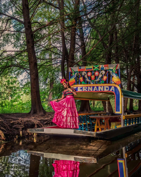 a bench that is next to a pond in the forest