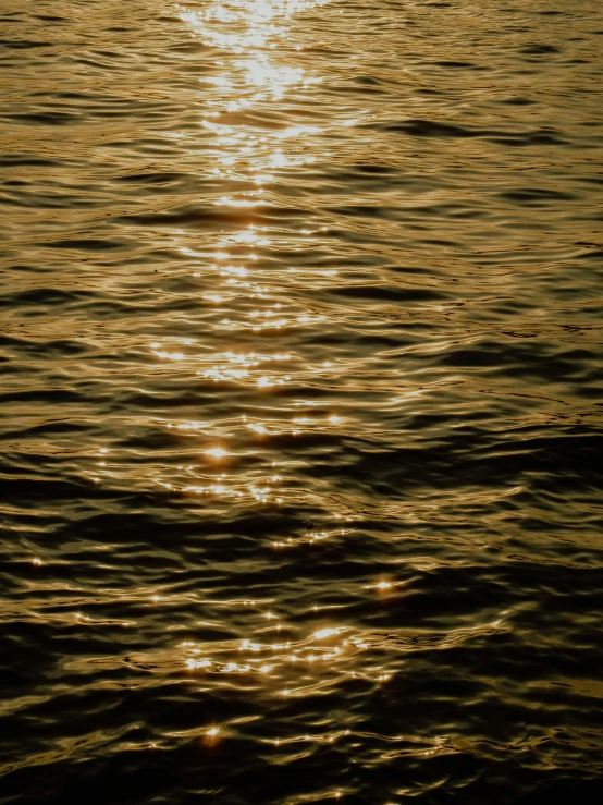 a sunset over the water has a bright yellow shine