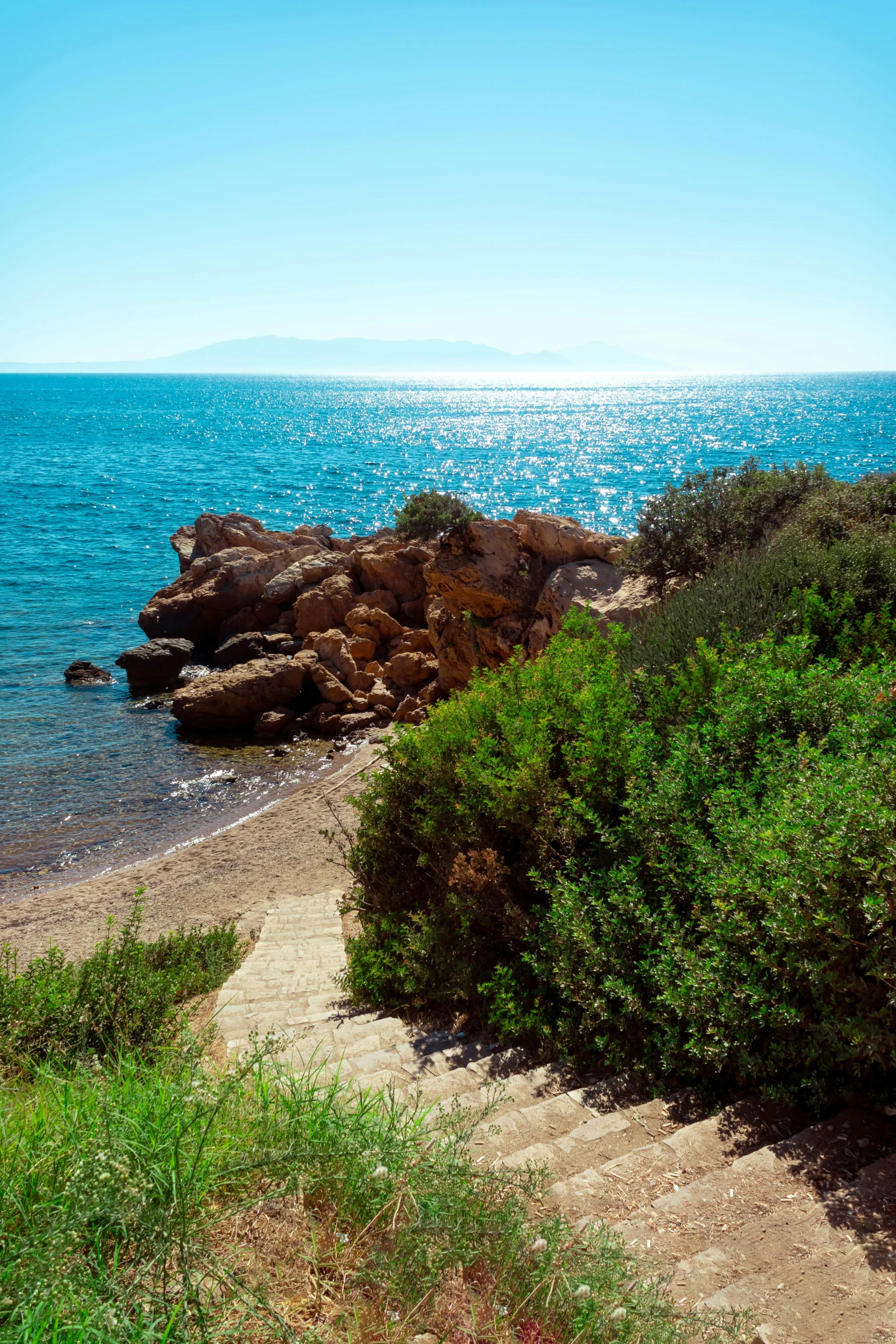 an ocean view from the shore on a sunny day