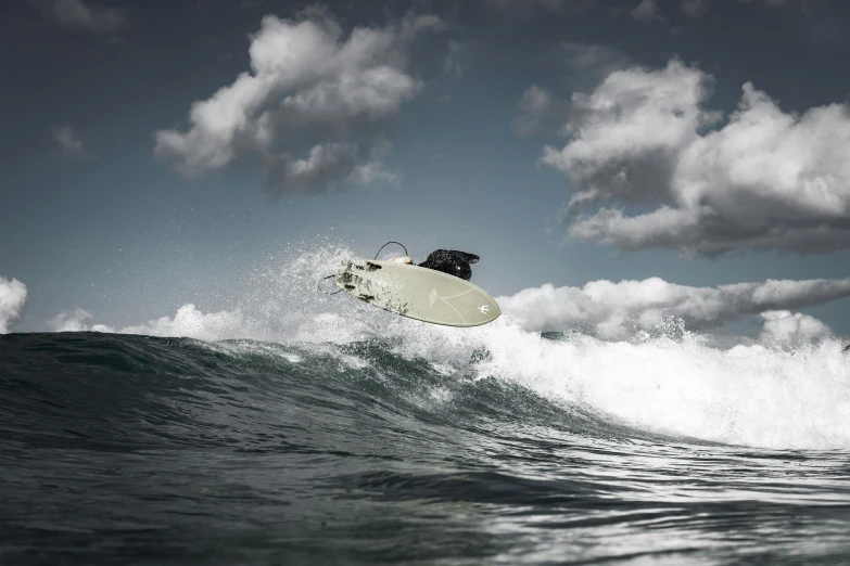 a person jumping over water in the air while riding a surf board