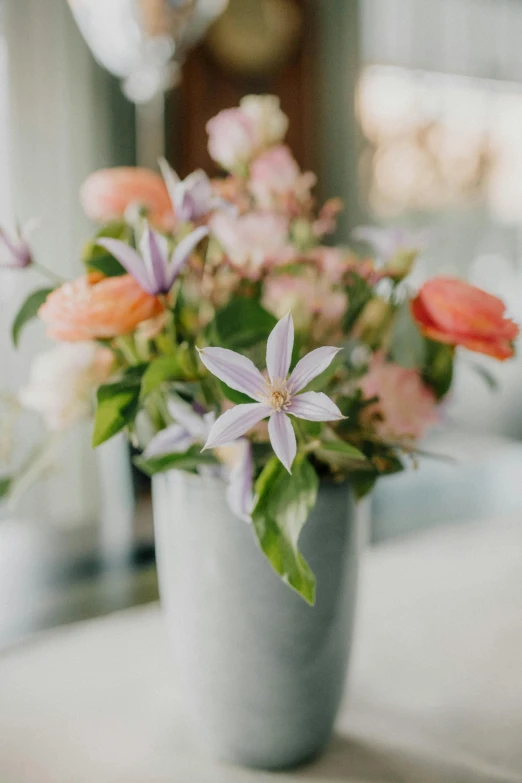 a floral bouquet in a stone vase on a table