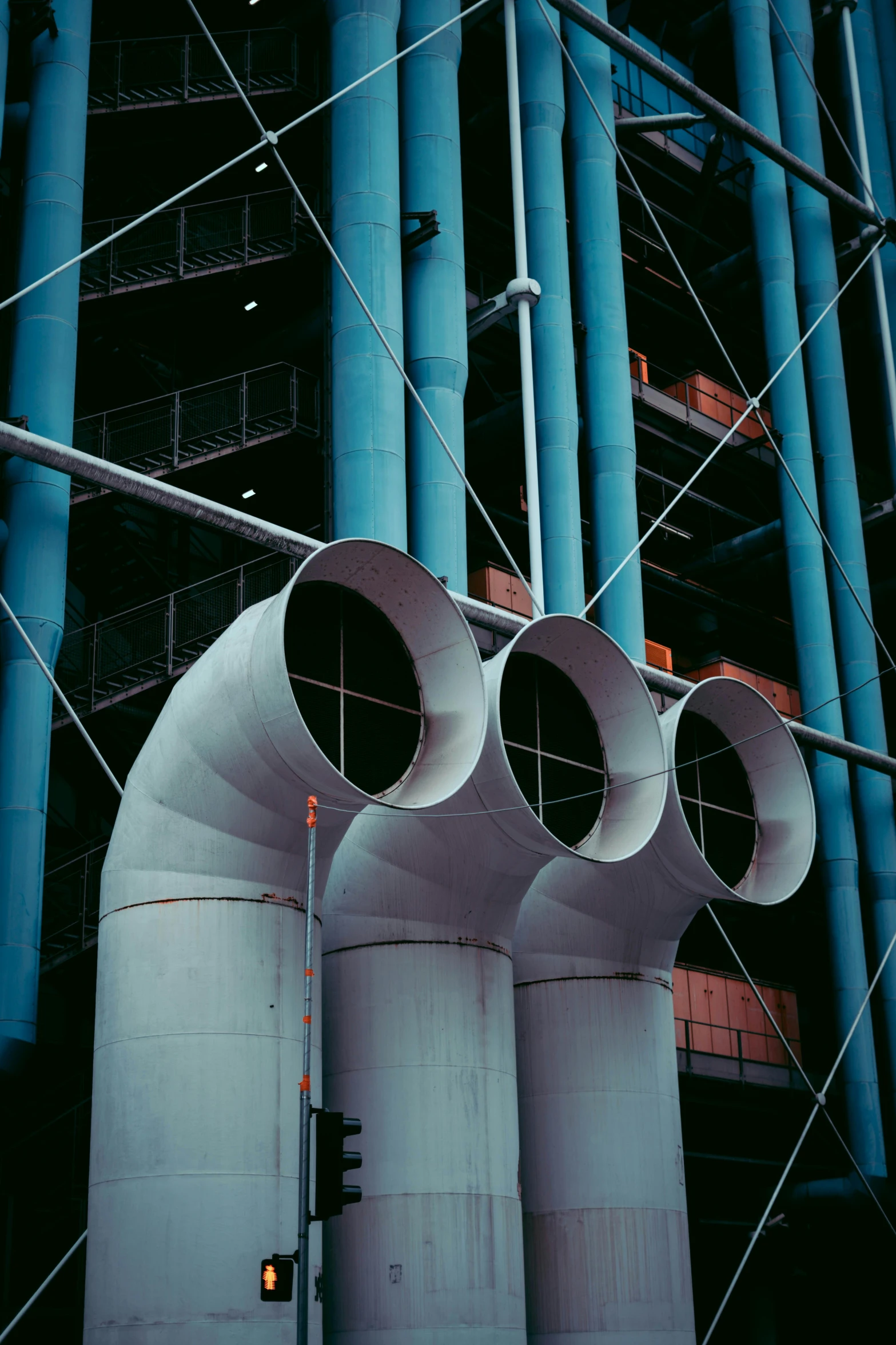 a large gray structure with pipes attached to it