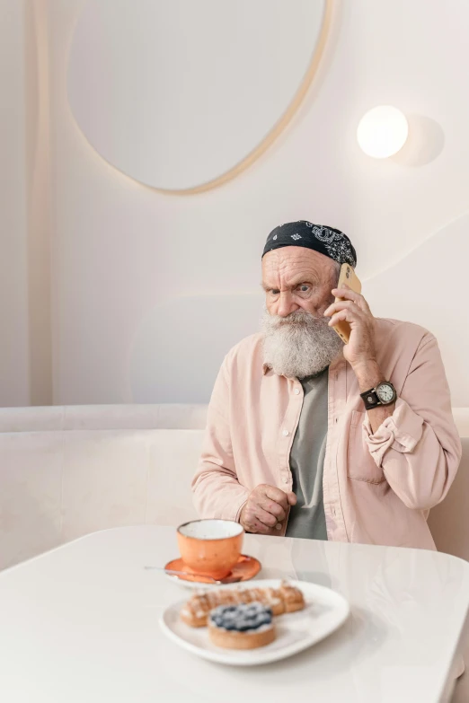 a man with a beard and mustache on a phone