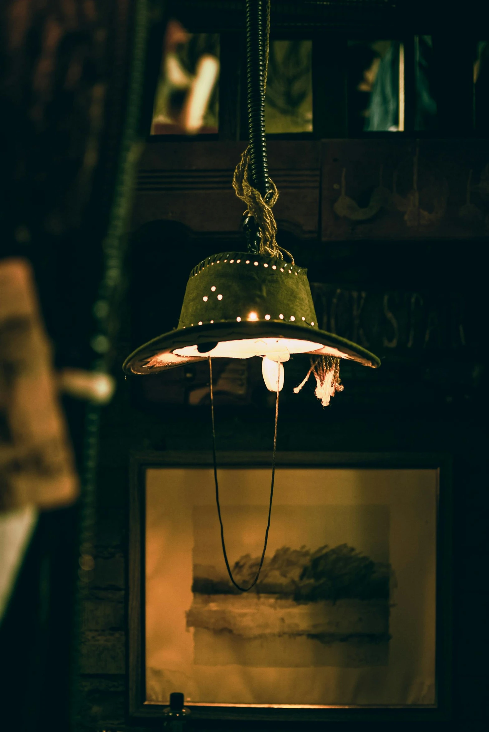 a large green light mounted on a wood beam