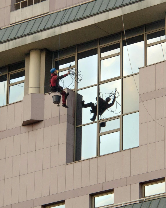 a man working on windows in a building