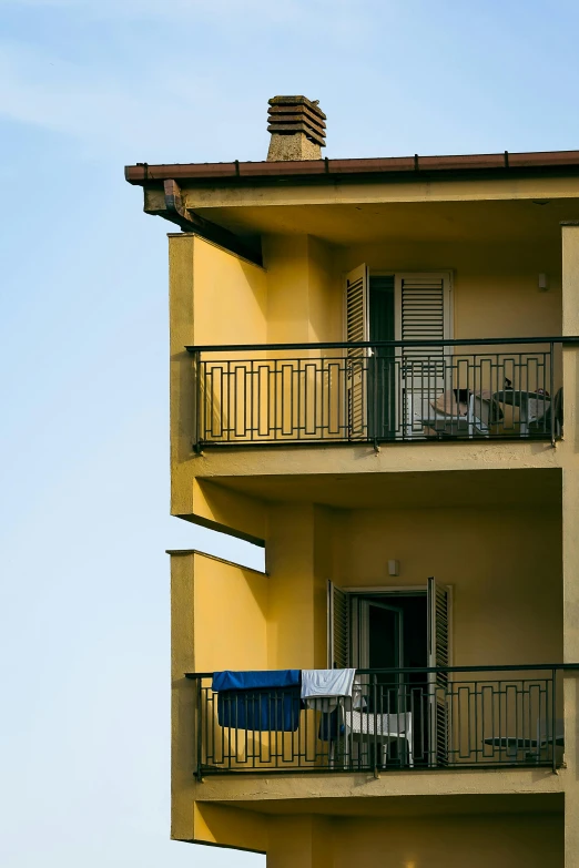 apartment building with balcony balconies and blue sky