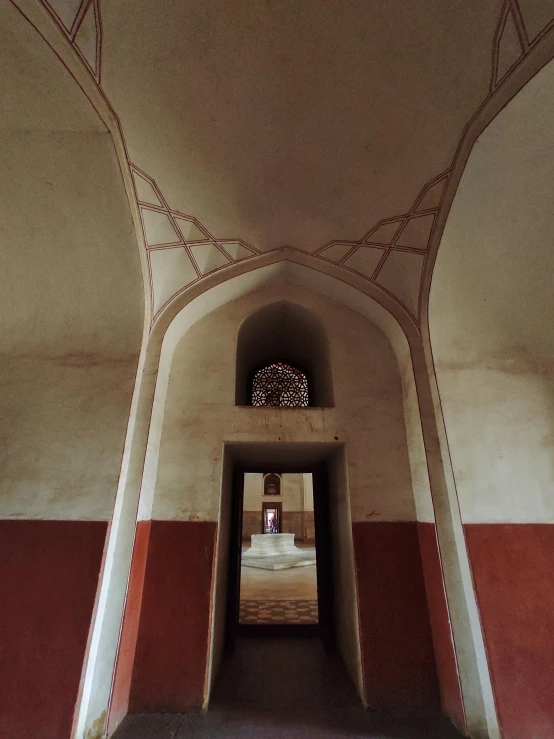 hallway with columns and a clock, painted in white and red