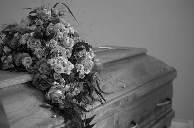 flowers are piled on top of an antique trunk