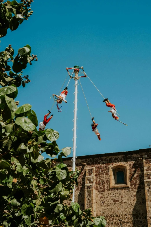 a group of people on skis doing a flip on a pole