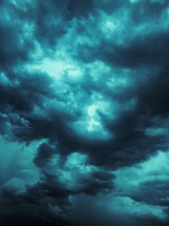 an airplane flying through a dark cloudy sky