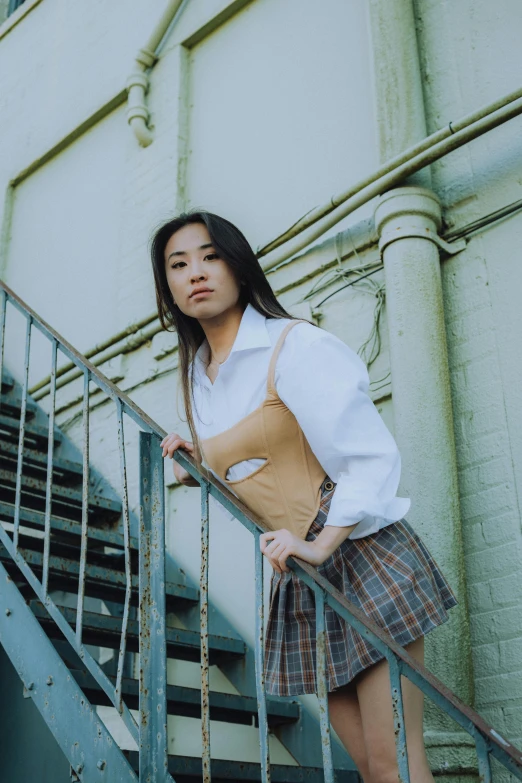 a young woman leaning on a handrail and looking back